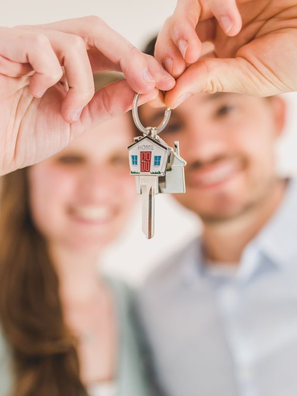 A couple holding the keys to their new home